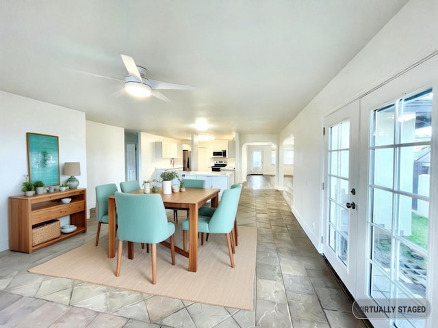 dining space with french doors and ceiling fan