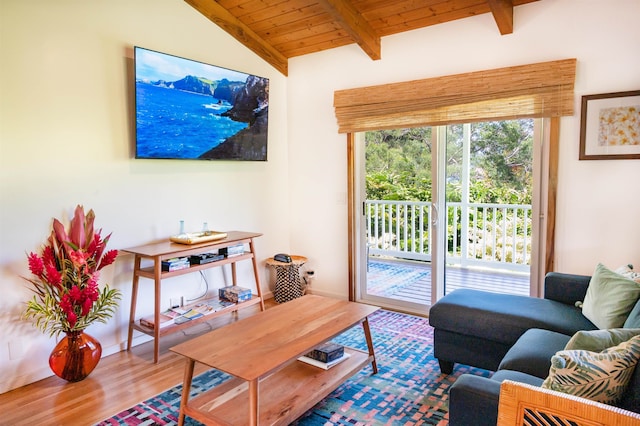 living room with vaulted ceiling with beams, hardwood / wood-style floors, and wooden ceiling