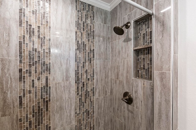 interior details with crown molding and a tile shower