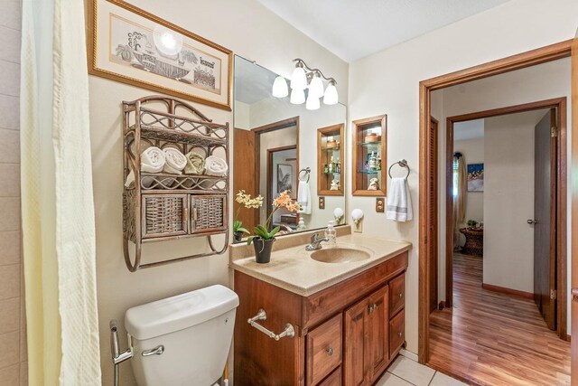 bathroom featuring toilet, tile patterned floors, and vanity