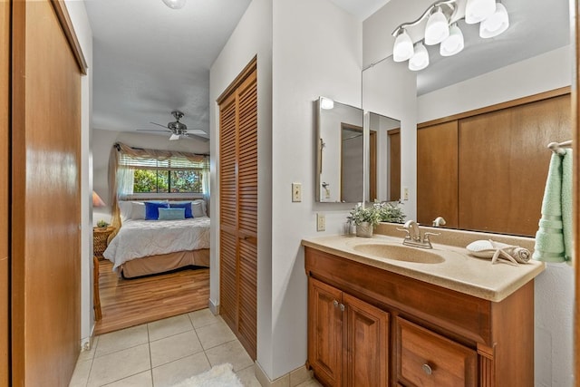 bathroom with ceiling fan, tile patterned floors, and vanity