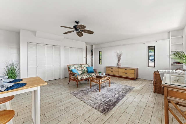 sitting room with ceiling fan and light wood-type flooring