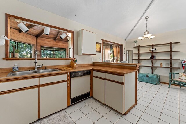 kitchen with white cabinets, dishwasher, decorative light fixtures, sink, and lofted ceiling with beams