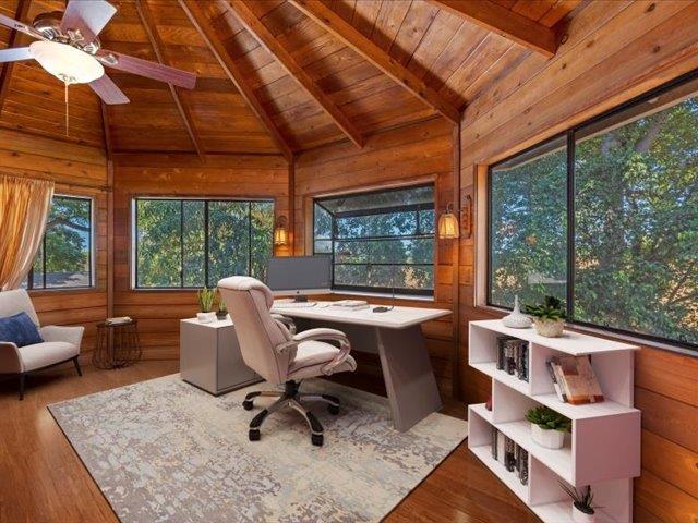 office area with a wealth of natural light, wood ceiling, wood-type flooring, and lofted ceiling with beams