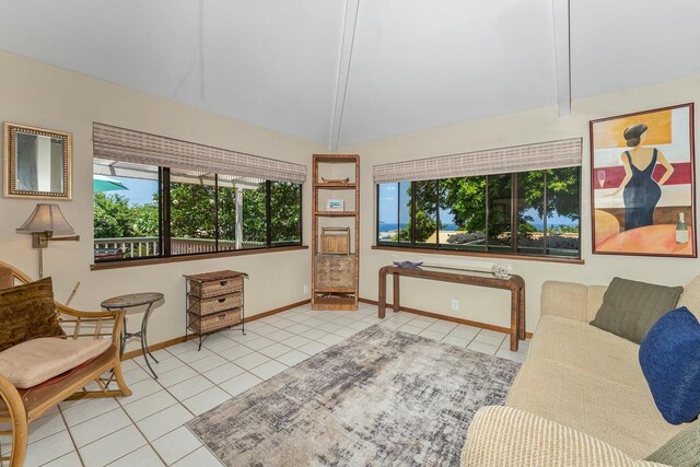 tiled living room with lofted ceiling with beams