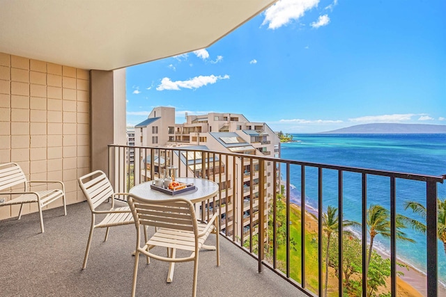 balcony featuring a water view and a beach view