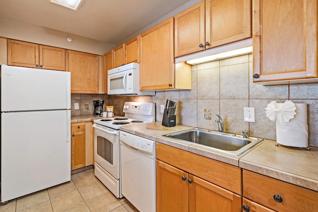 kitchen with light tile patterned floors, backsplash, sink, and white appliances