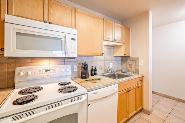 kitchen with decorative backsplash, sink, white appliances, light tile patterned flooring, and light brown cabinetry