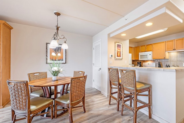 dining area featuring light wood-type flooring