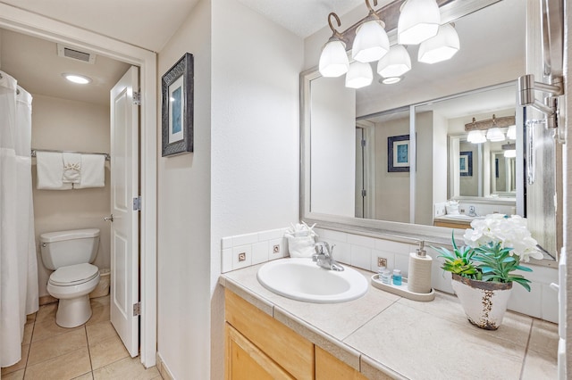 bathroom featuring toilet, tile patterned floors, and vanity