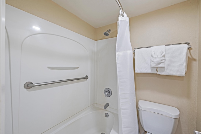 bathroom with toilet and shower / bathtub combination with curtain