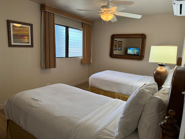 bedroom with ceiling fan and hardwood / wood-style floors