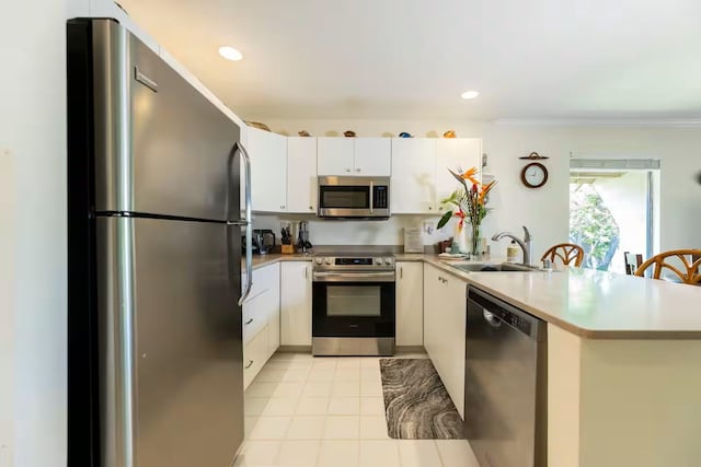 2777 S Kihei Rd Unit K 106, Kihei, HI 96753 - kitchen with appliances with stainless steel finishes, a sink, a peninsula, light countertops, and white cabinetry
