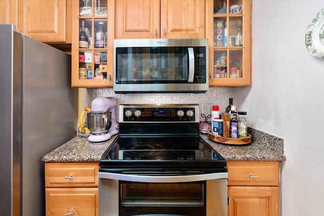 kitchen with tasteful backsplash and appliances with stainless steel finishes