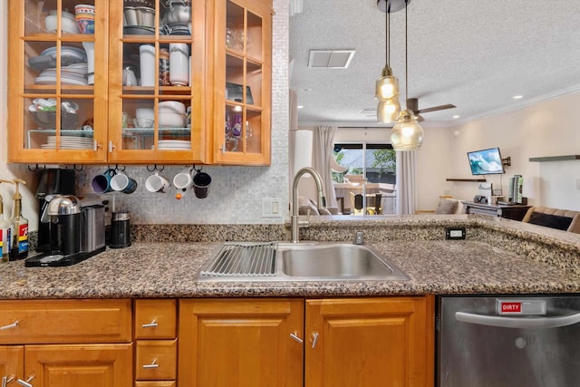 kitchen with pendant lighting, dishwasher, sink, a textured ceiling, and ornamental molding