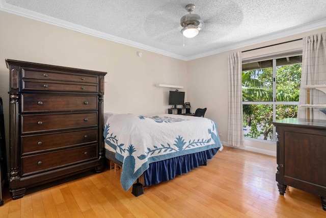 bedroom featuring crown molding, light wood-type flooring, a textured ceiling, and ceiling fan