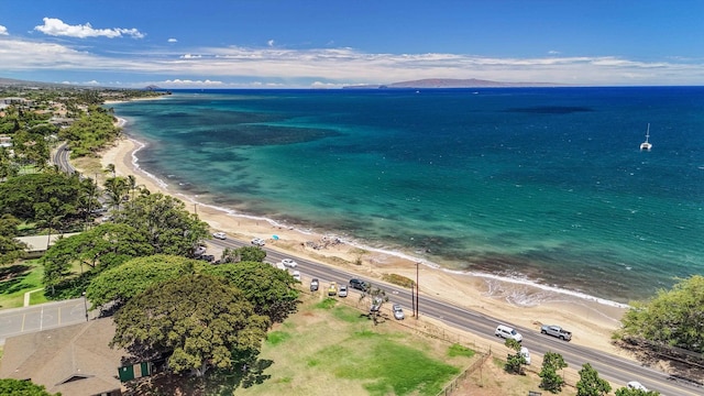 drone / aerial view featuring a water view and a beach view