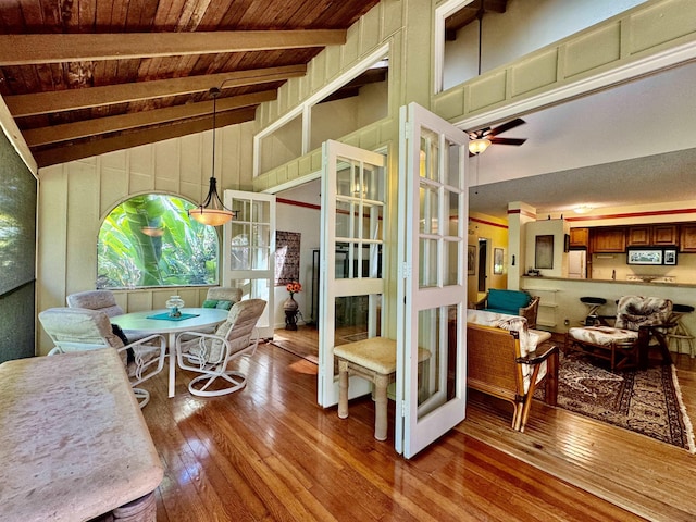 interior space with beam ceiling, ceiling fan, high vaulted ceiling, hardwood / wood-style floors, and wood ceiling