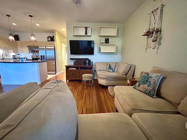 living room with light wood-type flooring and sink