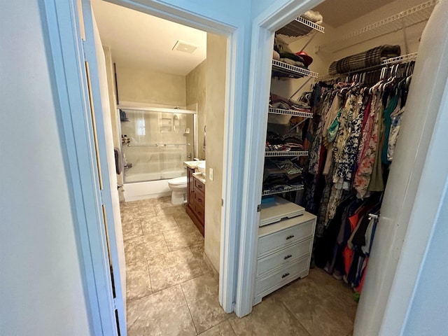 spacious closet featuring light tile patterned floors and visible vents