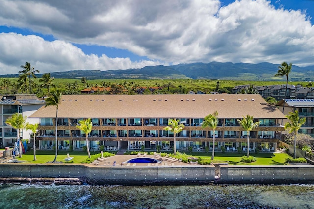 birds eye view of property featuring a water and mountain view