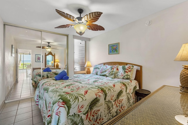 bedroom with tile patterned flooring, ceiling fan, and a closet