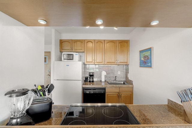 kitchen with tasteful backsplash, tile countertops, black appliances, light brown cabinets, and a sink