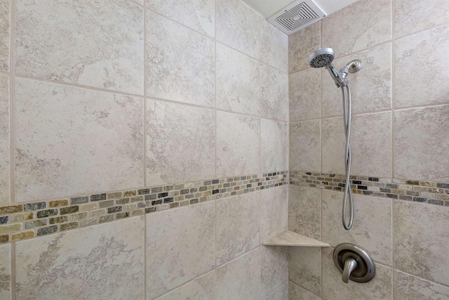 interior details with visible vents and a tile shower