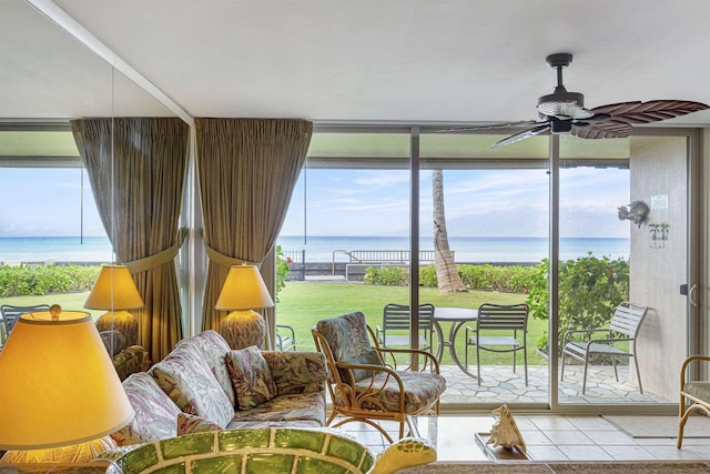 sunroom with a water view and a ceiling fan