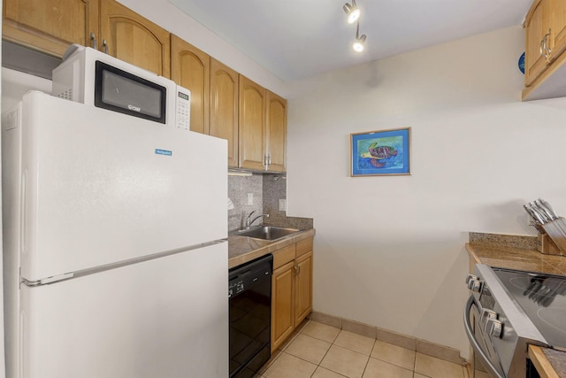 kitchen featuring black dishwasher, stainless steel electric stove, tasteful backsplash, freestanding refrigerator, and a sink