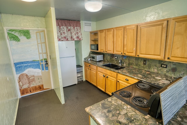 kitchen featuring black appliances, backsplash, and sink