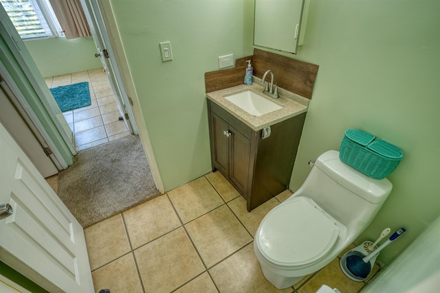 bathroom featuring vanity, toilet, and tile patterned flooring