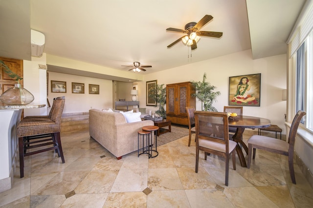 living area featuring ceiling fan and a wall mounted AC