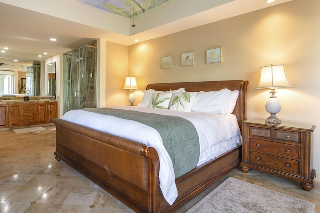 bedroom with ensuite bath and recessed lighting