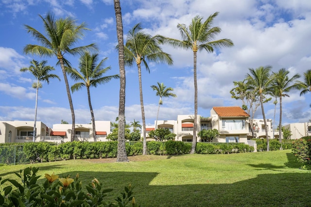 view of community with a residential view and a yard