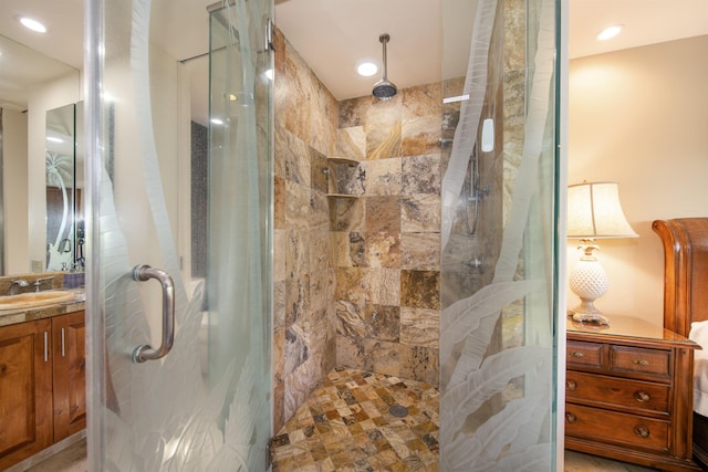 bathroom featuring recessed lighting, a shower stall, and vanity