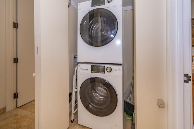 clothes washing area featuring laundry area and stacked washing maching and dryer