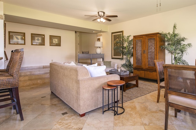 living area with ceiling fan and light tile patterned floors