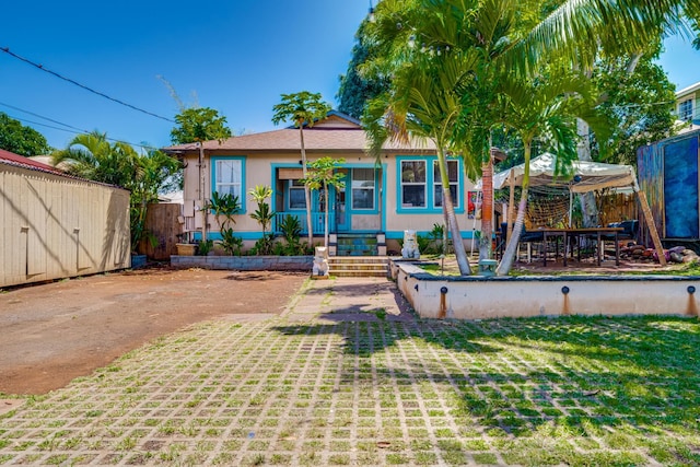 back of house with a lawn