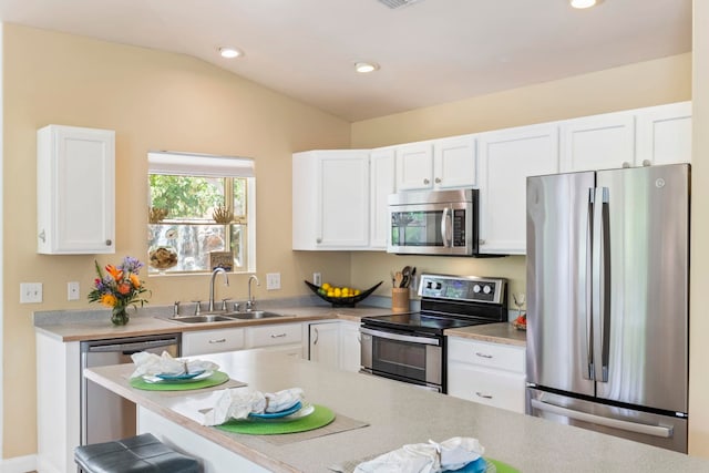 40 Hoola Lei Pl, Kihei, HI 96753 - kitchen with stainless steel appliances, a sink, white cabinets, light countertops, and vaulted ceiling