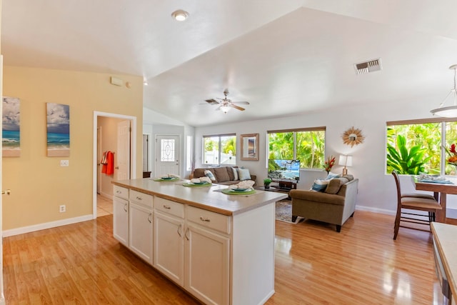 40 Hoola Lei Pl, Kihei, HI 96753 - kitchen featuring vaulted ceiling, open floor plan, white cabinets, light wood-style floors, and a ceiling fan