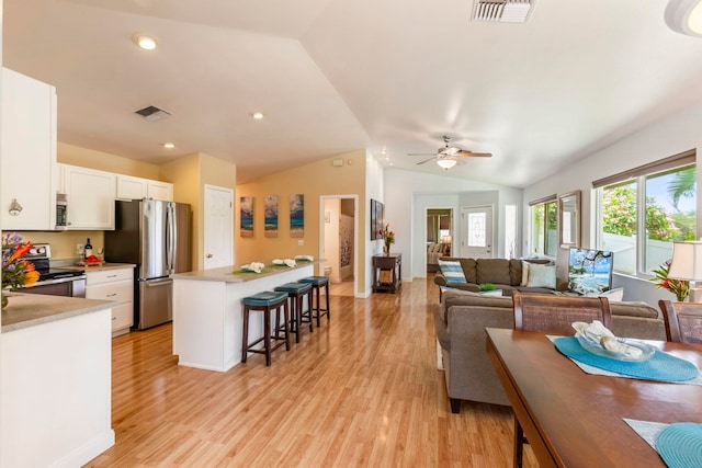 40 Hoola Lei Pl, Kihei, HI 96753 - living room with vaulted ceiling, light wood-style floors, a ceiling fan, and recessed lighting
