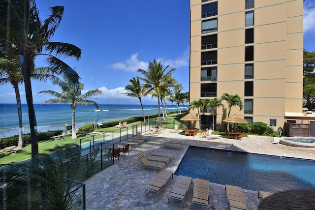 view of swimming pool with a water view and a patio