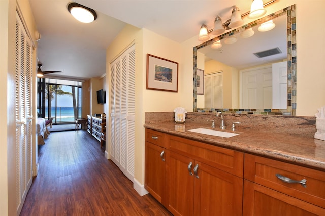 bathroom with ceiling fan, wood-type flooring, and vanity