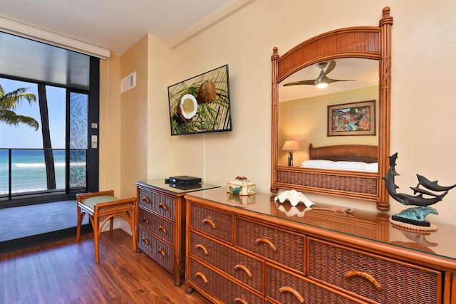 interior space with dark hardwood / wood-style floors and a water view