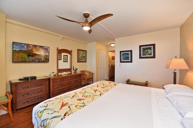 bedroom with ceiling fan, dark hardwood / wood-style flooring, ensuite bath, and a closet