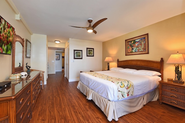 bedroom with dark hardwood / wood-style flooring and ceiling fan