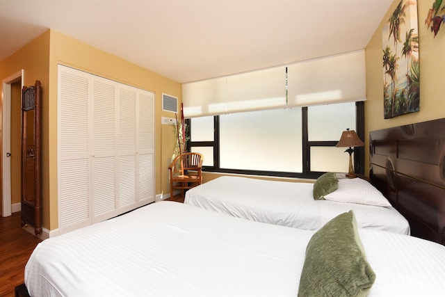 bedroom featuring hardwood / wood-style flooring and a closet