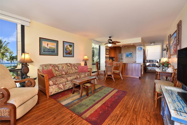 living room featuring dark hardwood / wood-style flooring and ceiling fan