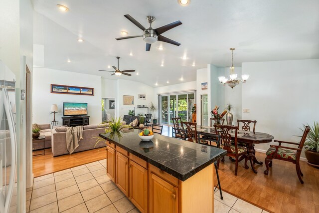 living room with light hardwood / wood-style flooring, ceiling fan, and lofted ceiling